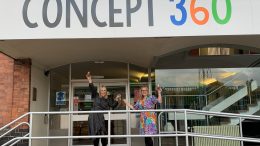 Katie Cooper Lewis is on the left and Victoria Prince is on the right and they are outside Concept 360 in Mansfield, raising a toast to Victoria's new office space.